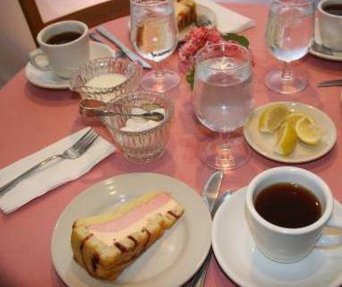 Steaming coffee and desserts on table setting