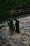 Rushing water hitting foot bridge