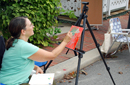 Artist Michele Frantz creating a painting during the Artwalk
